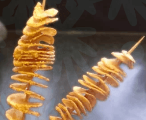Crispy spiral-cut potato on a stick, deep-fried to golden perfection and topped with a drizzle of nacho cheese, zesty ranch, or mayo, served hot as a street food snack.